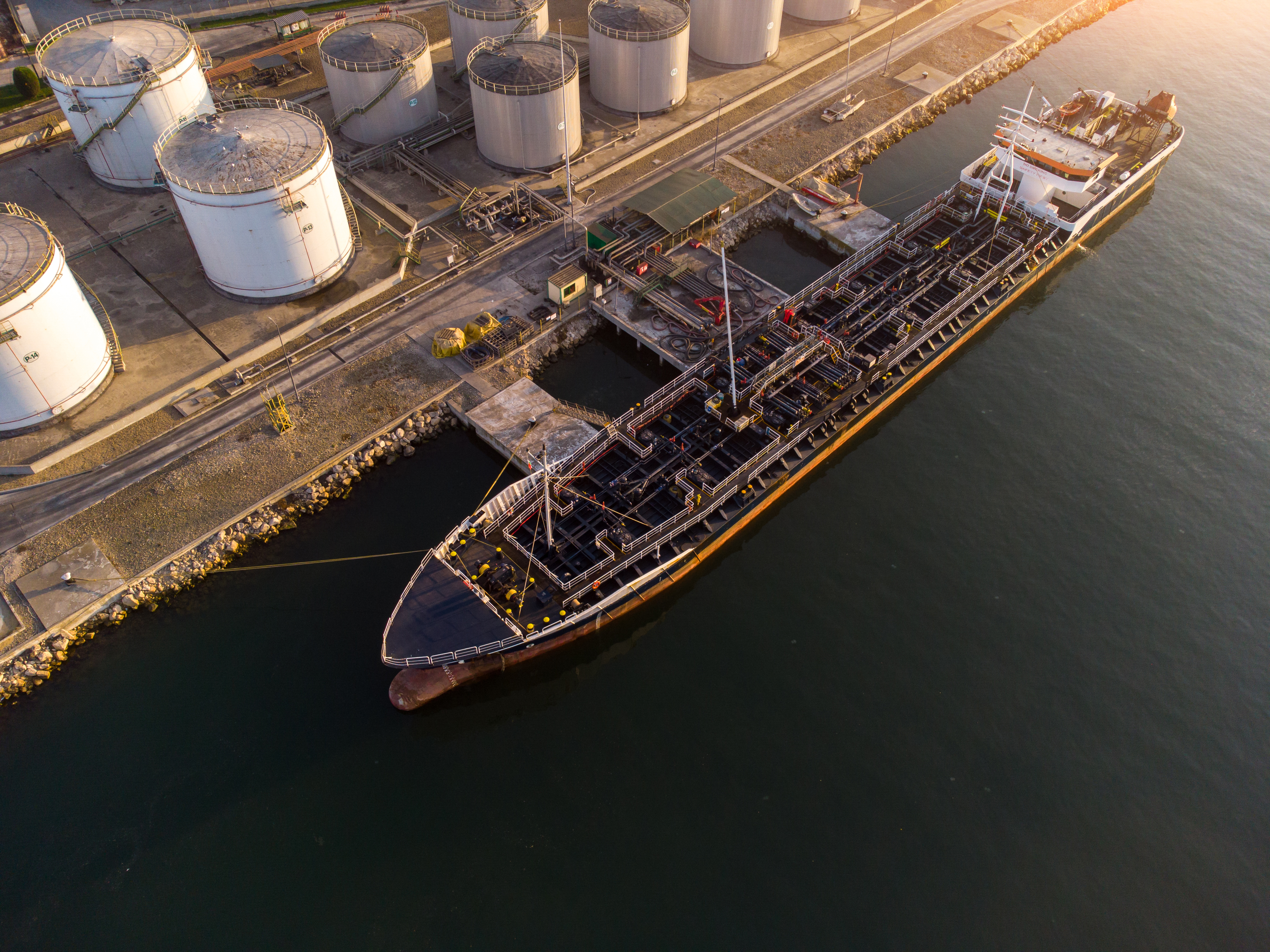 Tanker berthed alongside an oil storage terminal